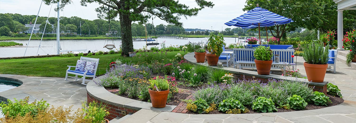 CMS Landscape A Waterfront Estate Rooted in Legacy, Refined for Today, a new project feature from CMS Landscape. This property includes a stunning backyard that lines the waterfront with a beautiful patio and swimming pool and lots of flowers and shrubs.