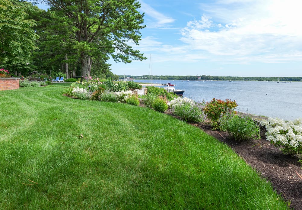 CMS Landscape A Waterfront Estate Rooted in Legacy, Refined for Today, a new project feature from CMS Landscape. This property includes a stunning backyard that lines the waterfront with a beautiful patio and swimming pool and lots of flowers and shrubs.
