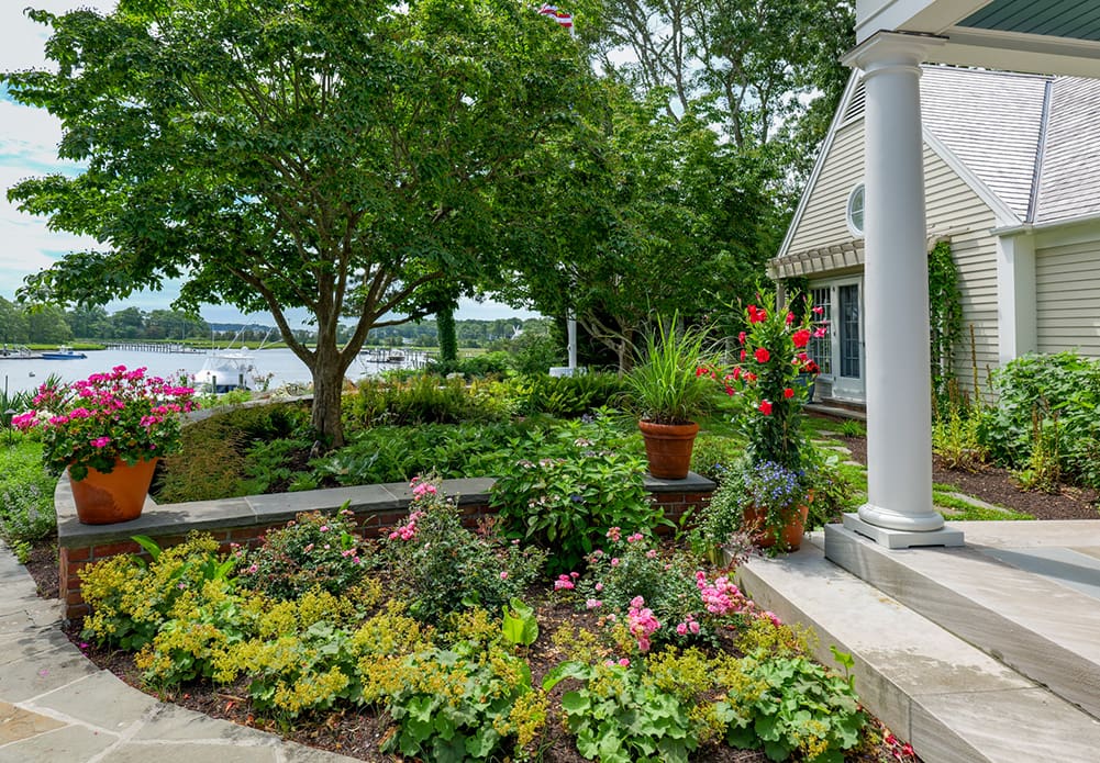 CMS Landscape A Waterfront Estate Rooted in Legacy, Refined for Today, a new project feature from CMS Landscape. This property includes a stunning backyard that lines the waterfront with a beautiful patio and swimming pool and lots of flowers and shrubs.