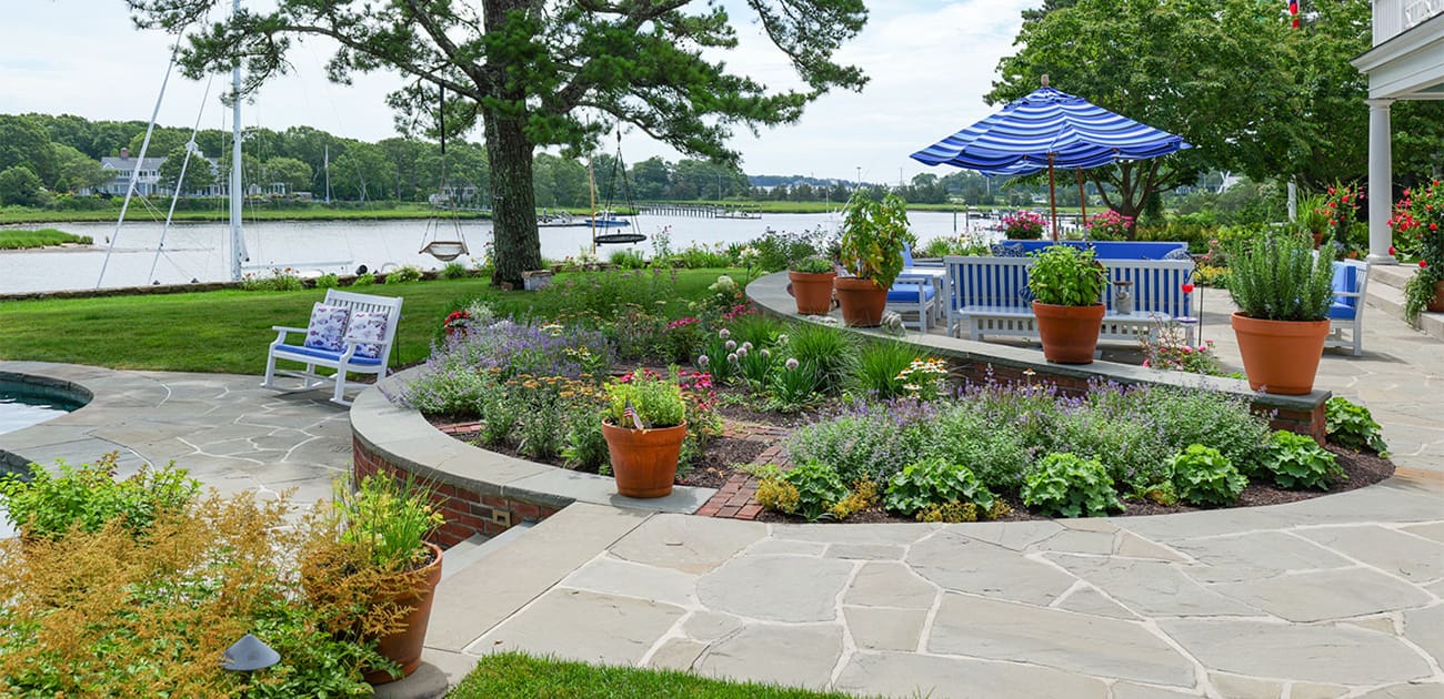 CMS Landscape A Waterfront Estate Rooted in Legacy, Refined for Today, a new project feature from CMS Landscape. This property includes a stunning backyard that lines the waterfront with a beautiful patio and swimming pool and lots of flowers and shrubs.