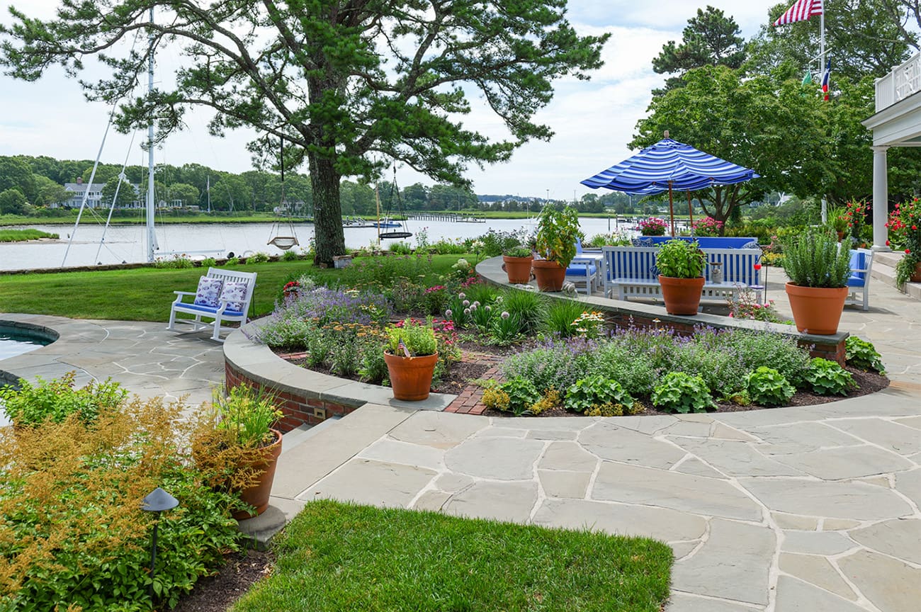 CMS Landscape A Waterfront Estate Rooted in Legacy, Refined for Today, a new project feature from CMS Landscape. This property includes a stunning backyard that lines the waterfront with a beautiful patio and swimming pool and lots of flowers and shrubs.