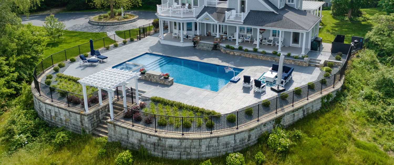 A beautiful landscaping project complete with swimming pool and retaining wall perimeter, built, designed, and maintained by CMS Landscape