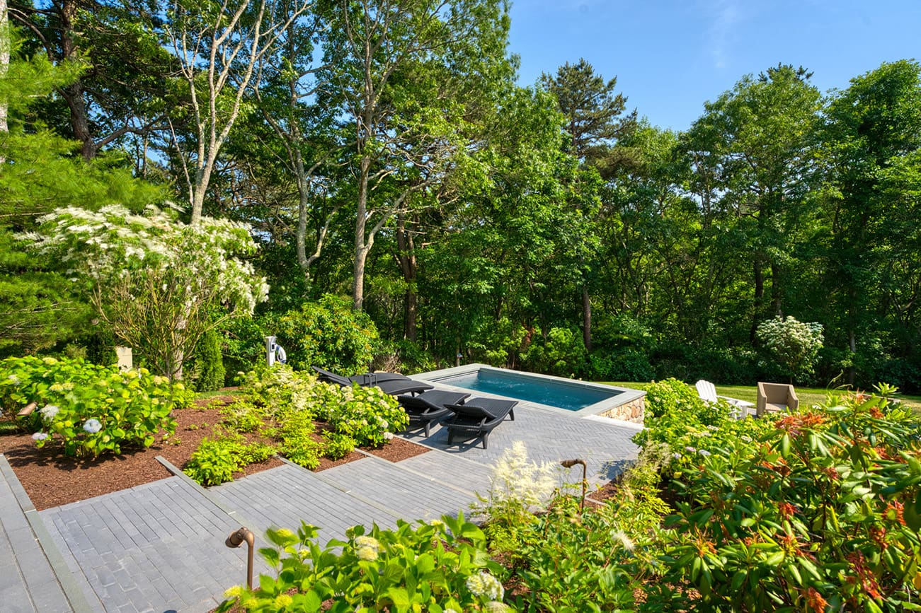 A beautiful landscaping project complete with swimming pool and gorgeous flowers, built, designed, and maintained by CMS Landscape