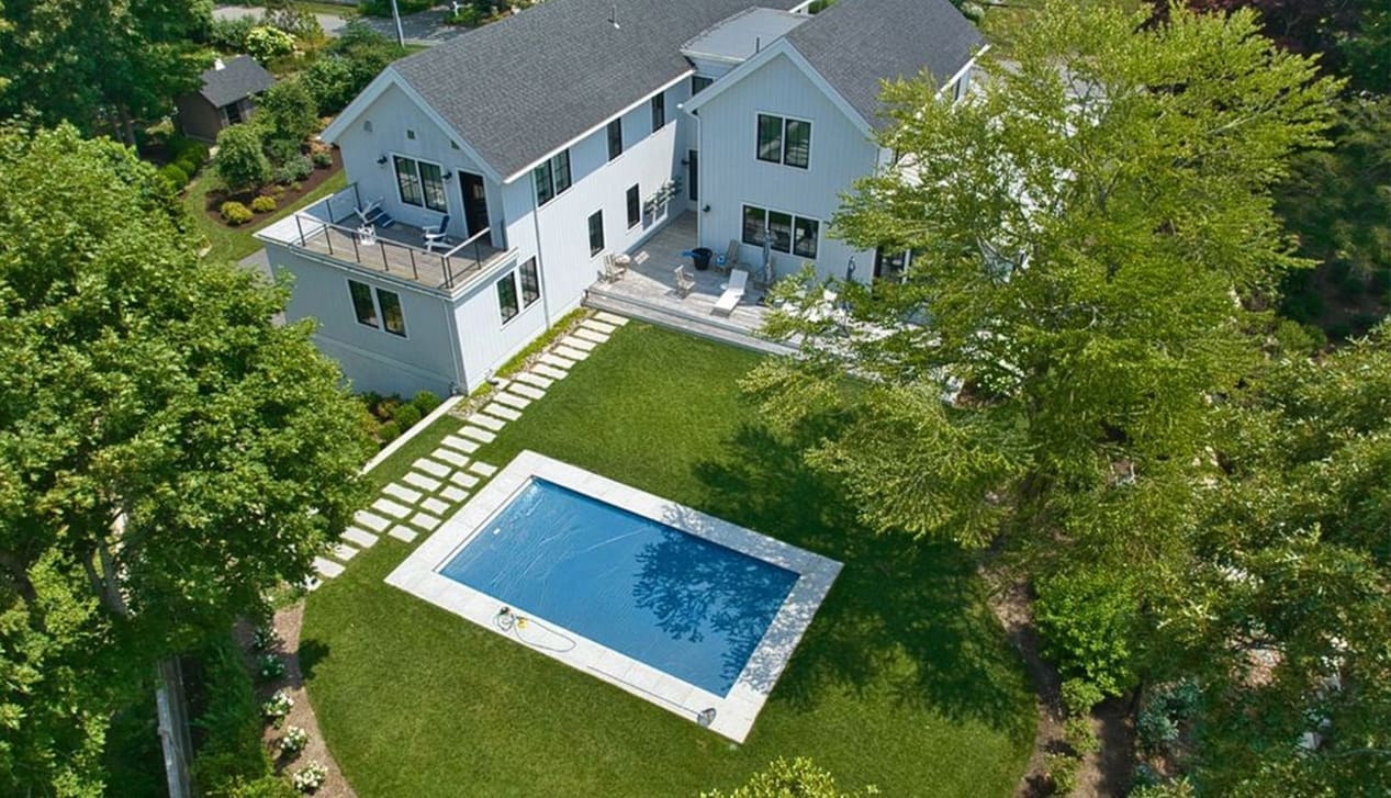 CMS A beautiful house with a backyard pool, a property managed by CMS Landscape