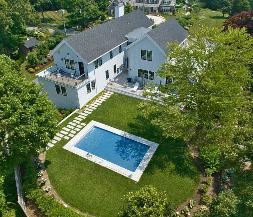 A beautiful house with a backyard pool, a property managed by CMS Landscape